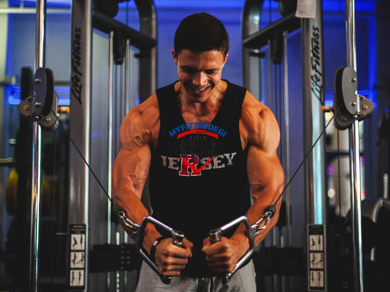 Gym cable machine crossover position with chest squeeze.