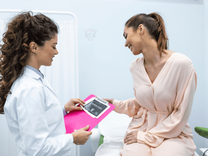 Smiling woman consulting doctor for PCOD vs PCOS treatment options